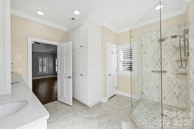 a view of a bathroom with a shower and a sink
