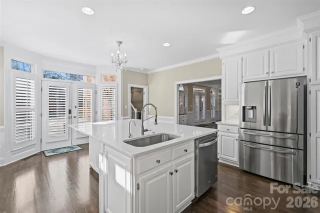 a kitchen with stainless steel appliances granite countertop a refrigerator sink and stove