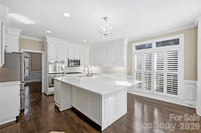 a kitchen with stainless steel appliances a sink stove and refrigerator