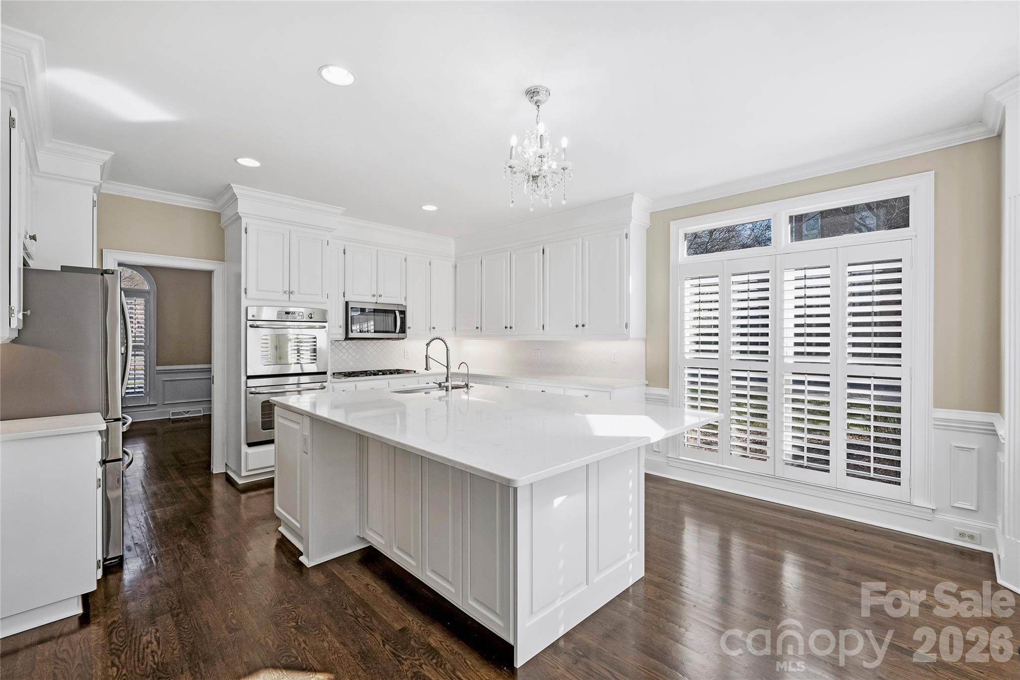 5242 Colony Road Charlotte, NC 28226 - Photo 8 of 34 a kitchen with stainless steel appliances a sink stove and refrigerator