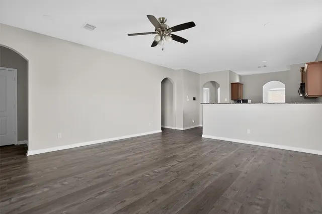 a view of a kitchen with wooden floor and a ceiling fan