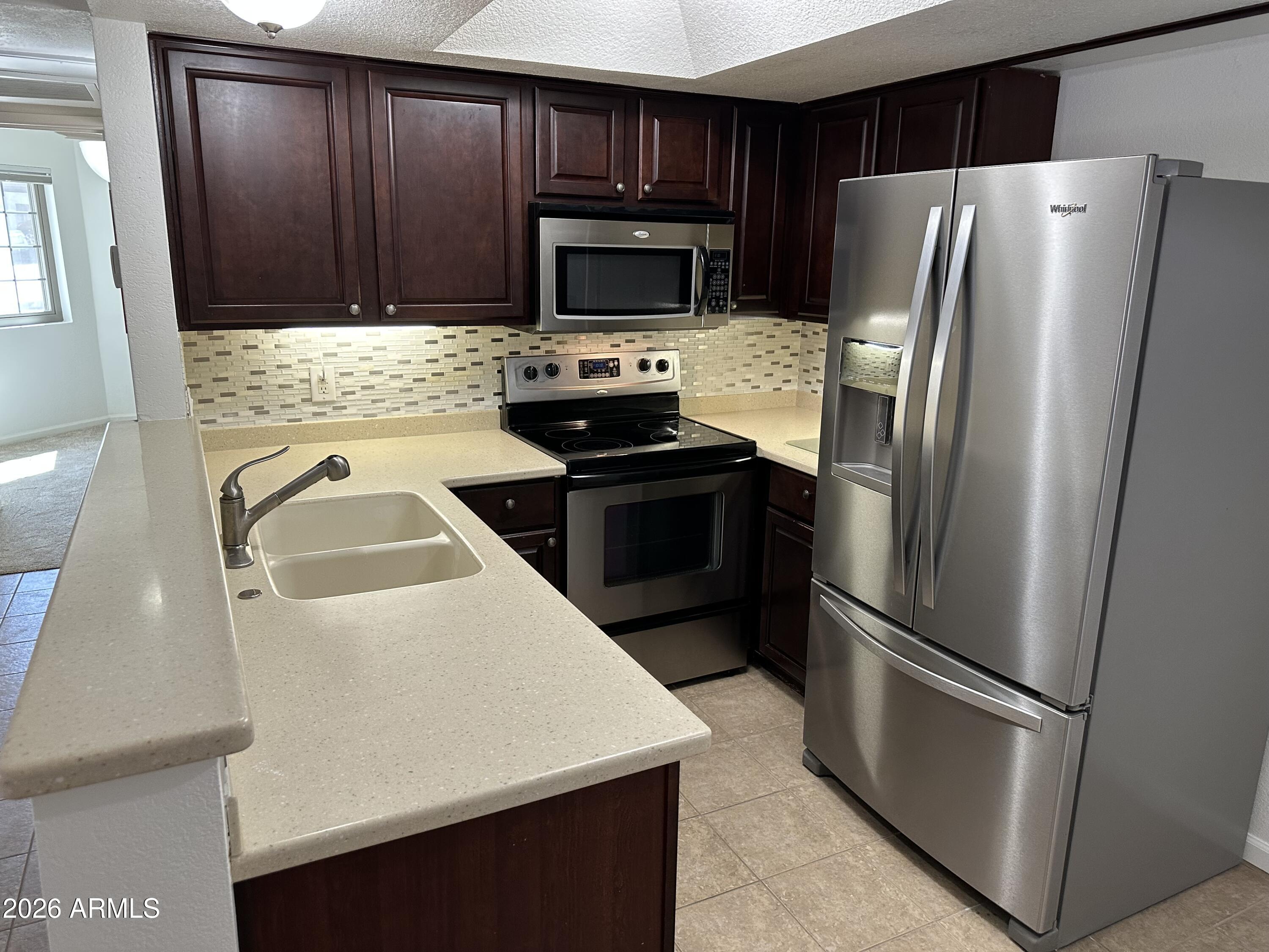1720 East Thunderbird Road, Unit 1019 Phoenix, AZ 85022 - Photo 18 of 47 a kitchen with a refrigerator sink and microwave