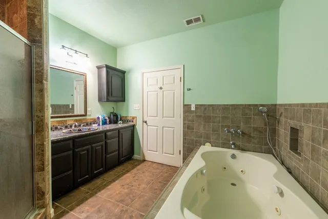 a bathroom with a bathtub and a sink