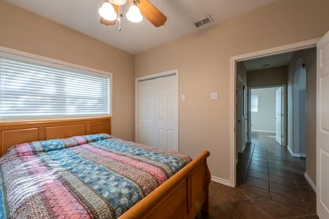 a bedroom with a bed and a window