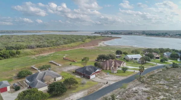 a view of a lake with lawn chairs