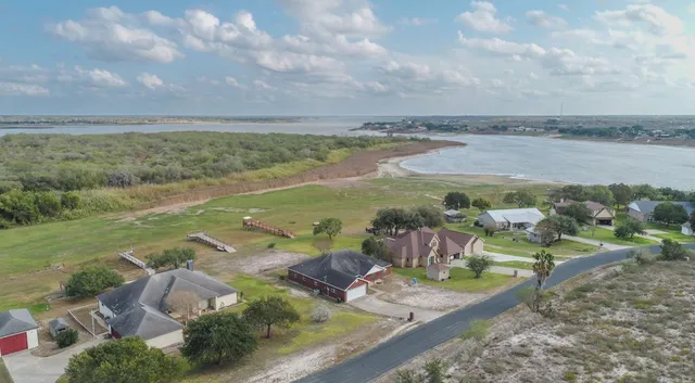 a view of a lake with lawn chairs