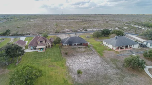 an aerial view of residential houses with outdoor space and swimming pool