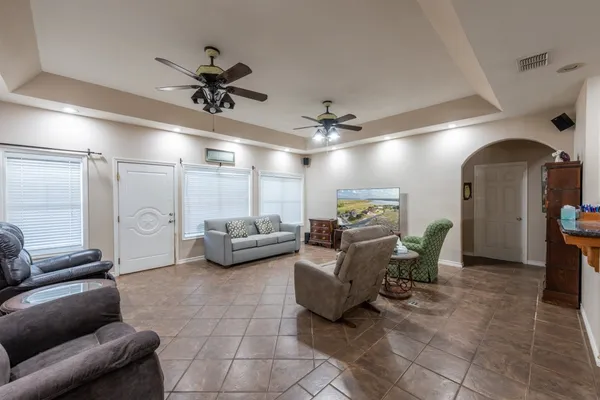 a view of a livingroom with furniture and a ceiling fan