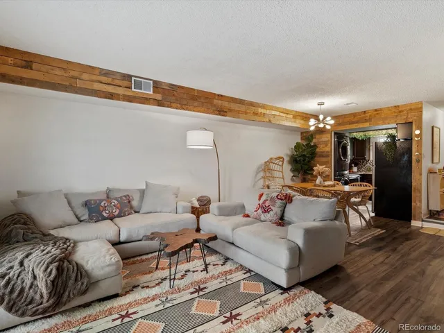 a living room with furniture and a chandelier