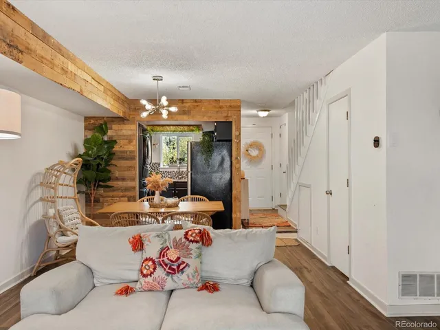 a living room with furniture and a chandelier
