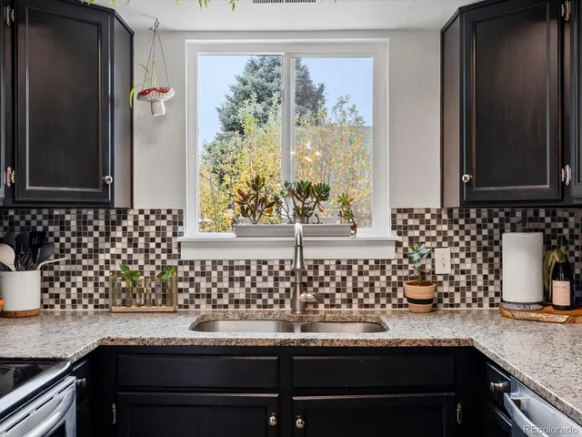 a kitchen with a sink stove and microwave