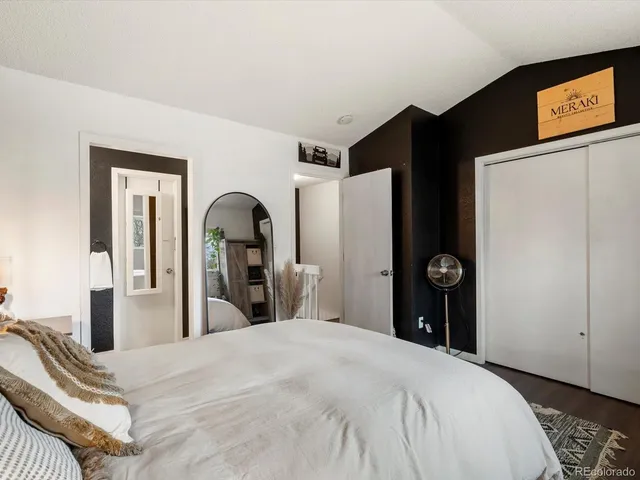 a bedroom with a bed and a mirror