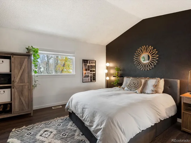 a bedroom with a bed and a couch