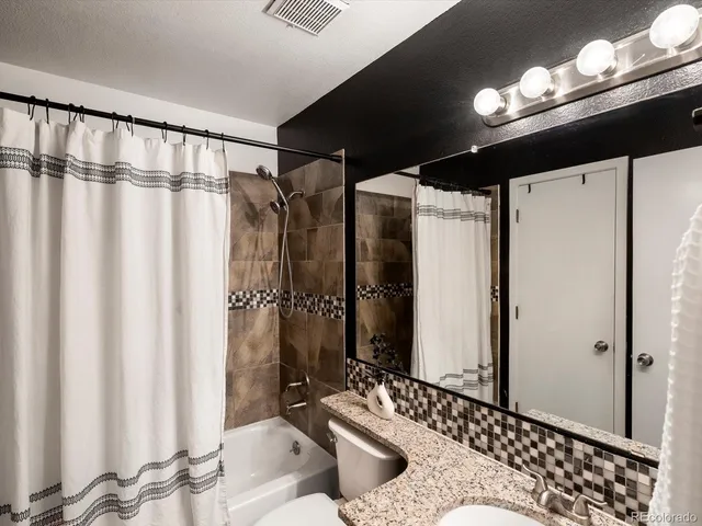 a bedroom with a bed and a desk