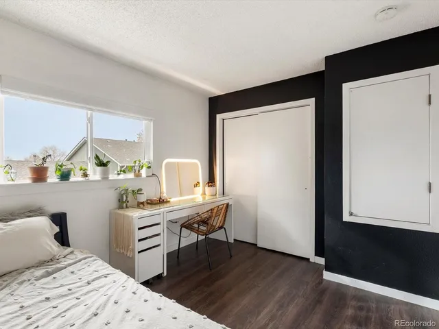 a bedroom with a bed and a desk