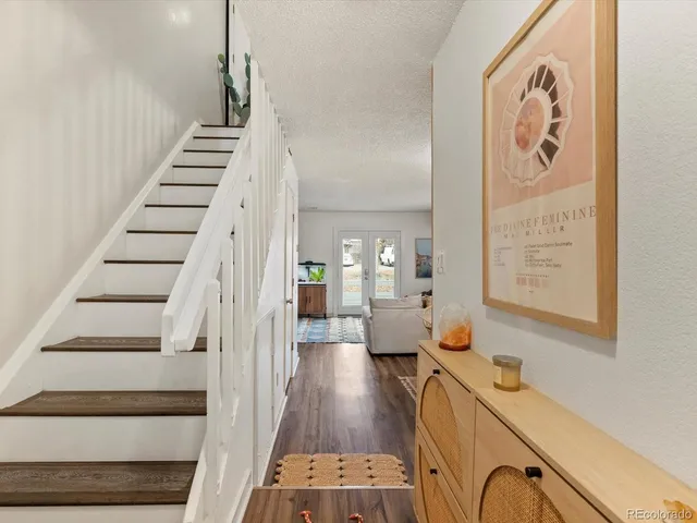 a view of entryway and hall with wooden floor