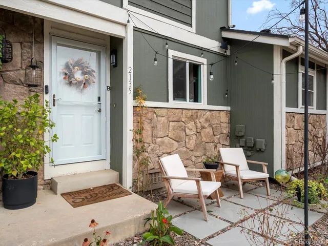 a view of a patio with table and chairs and potted plants