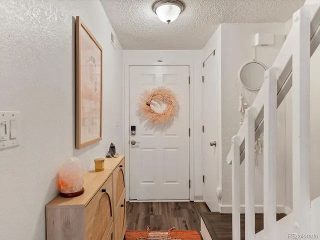 a bathroom with a granite countertop sink a mirror and shower