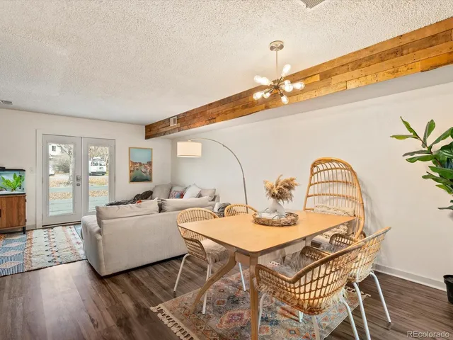 a dining room with furniture and wooden floor