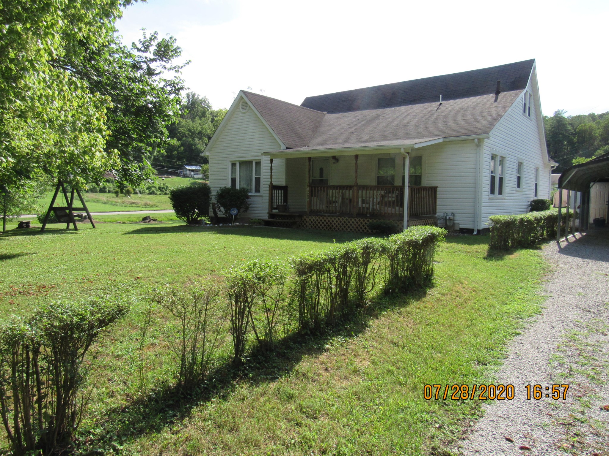 1207 Spring Street Lancing, TN 37770 - Photo 1 of 19 a front view of house with yard and green space