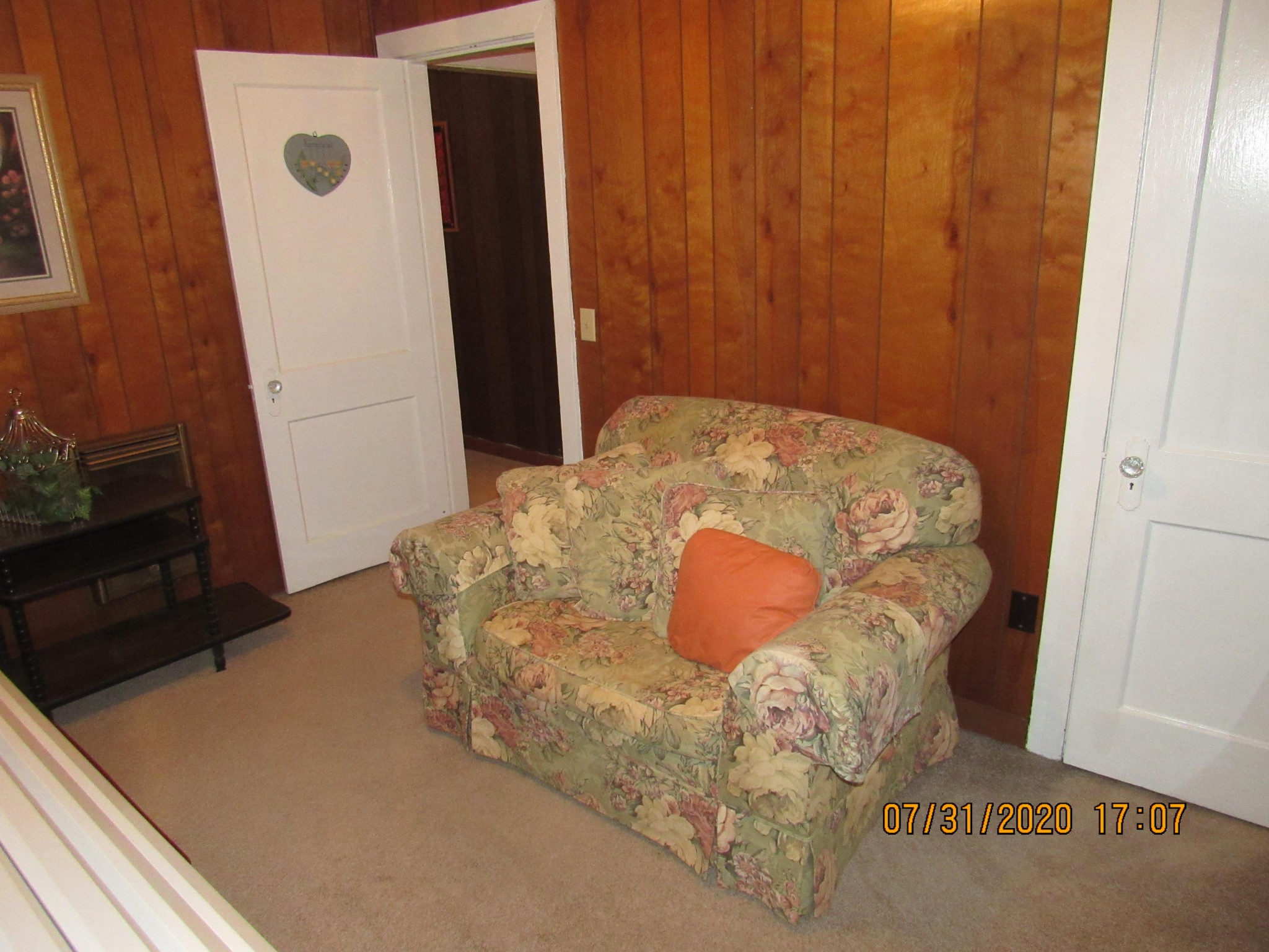 1207 Spring Street Lancing, TN 37770 - Photo 16 of 19 a bed sitting in a bedroom next to a wooden door