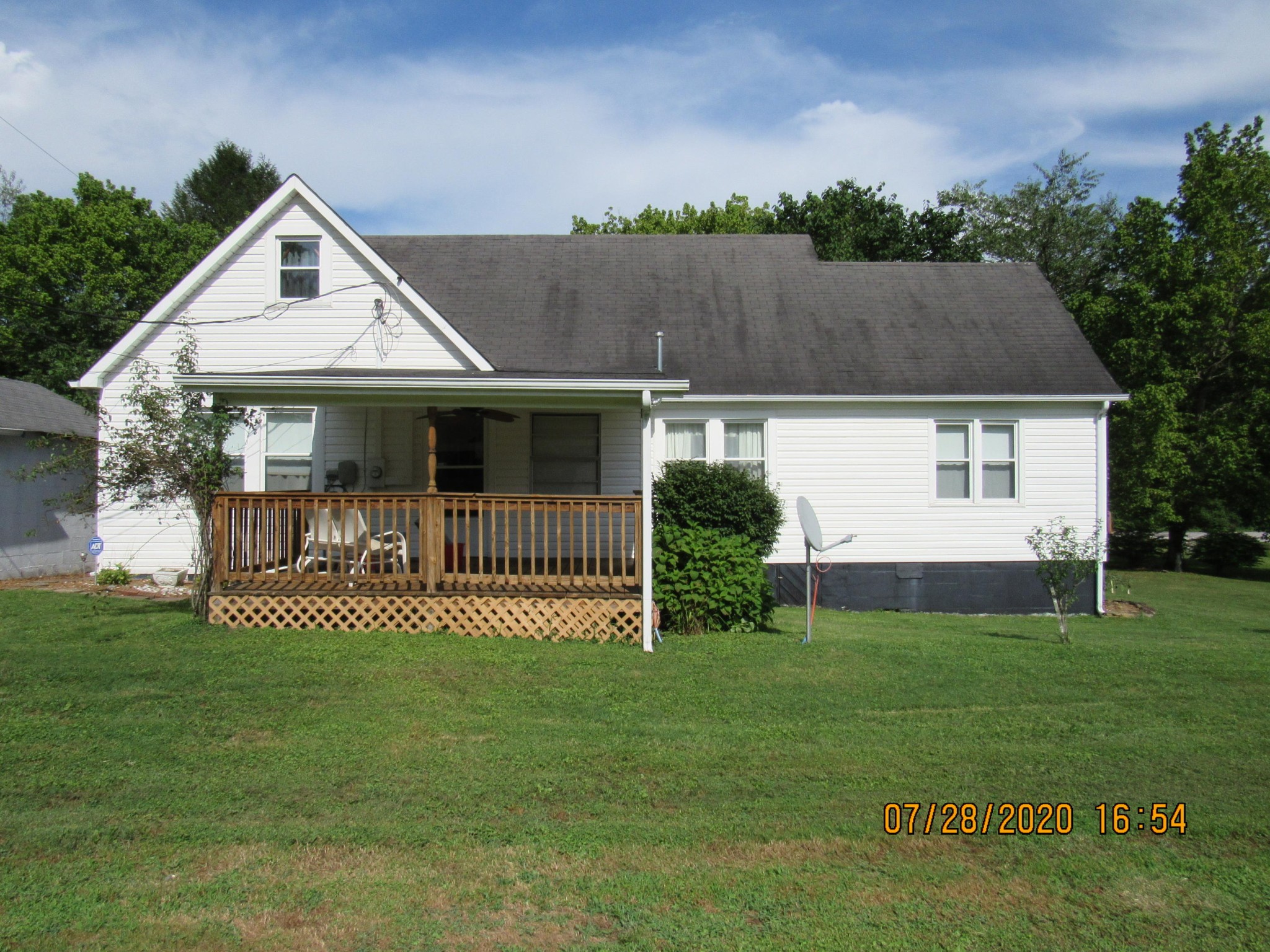 1207 Spring Street Lancing, TN 37770 - Photo 5 of 19 a front view of a house with a garden