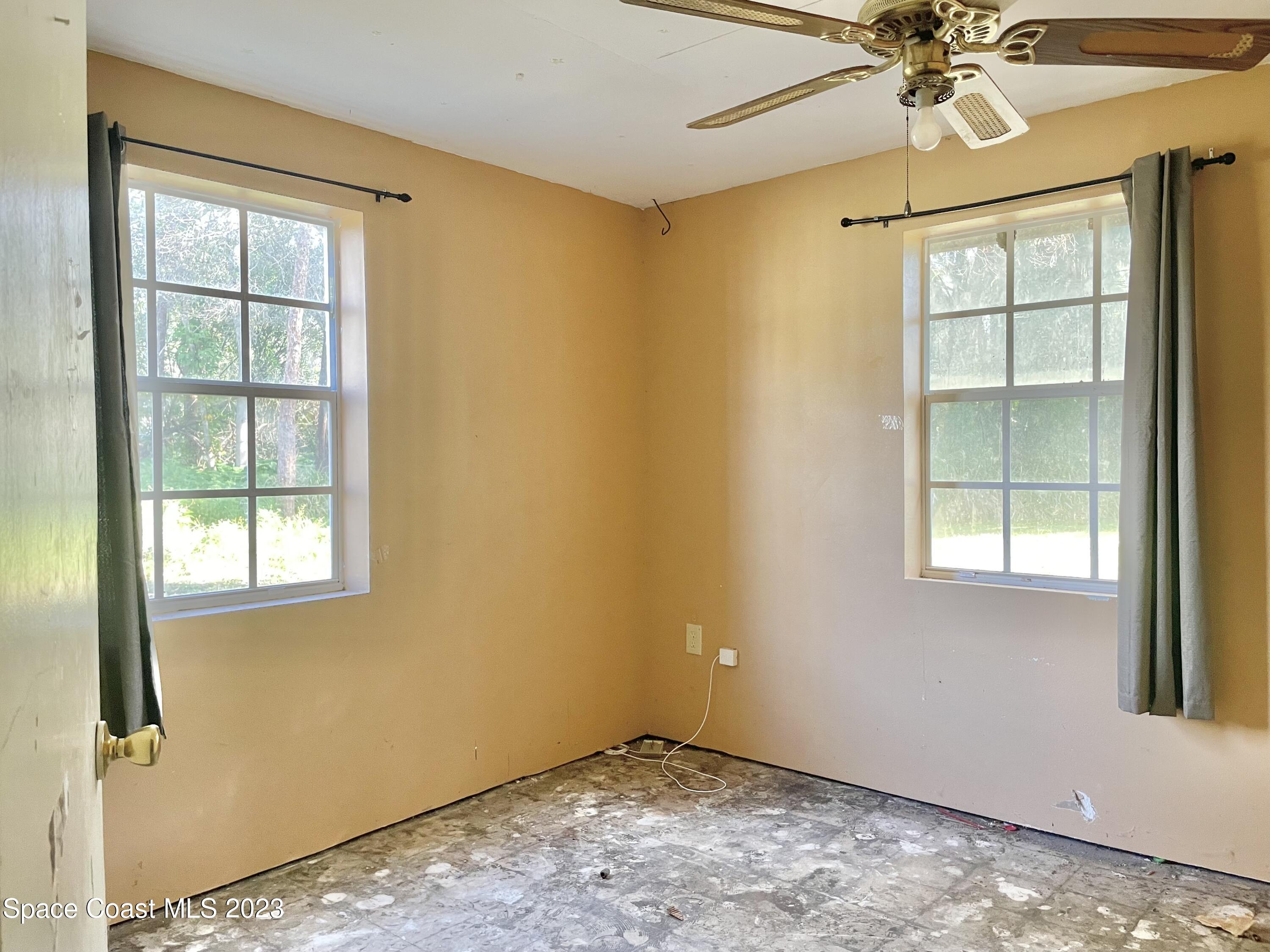 2245 Commodore Boulevard Melbourne, FL 32904 - Photo 12 of 15 an empty room with a window