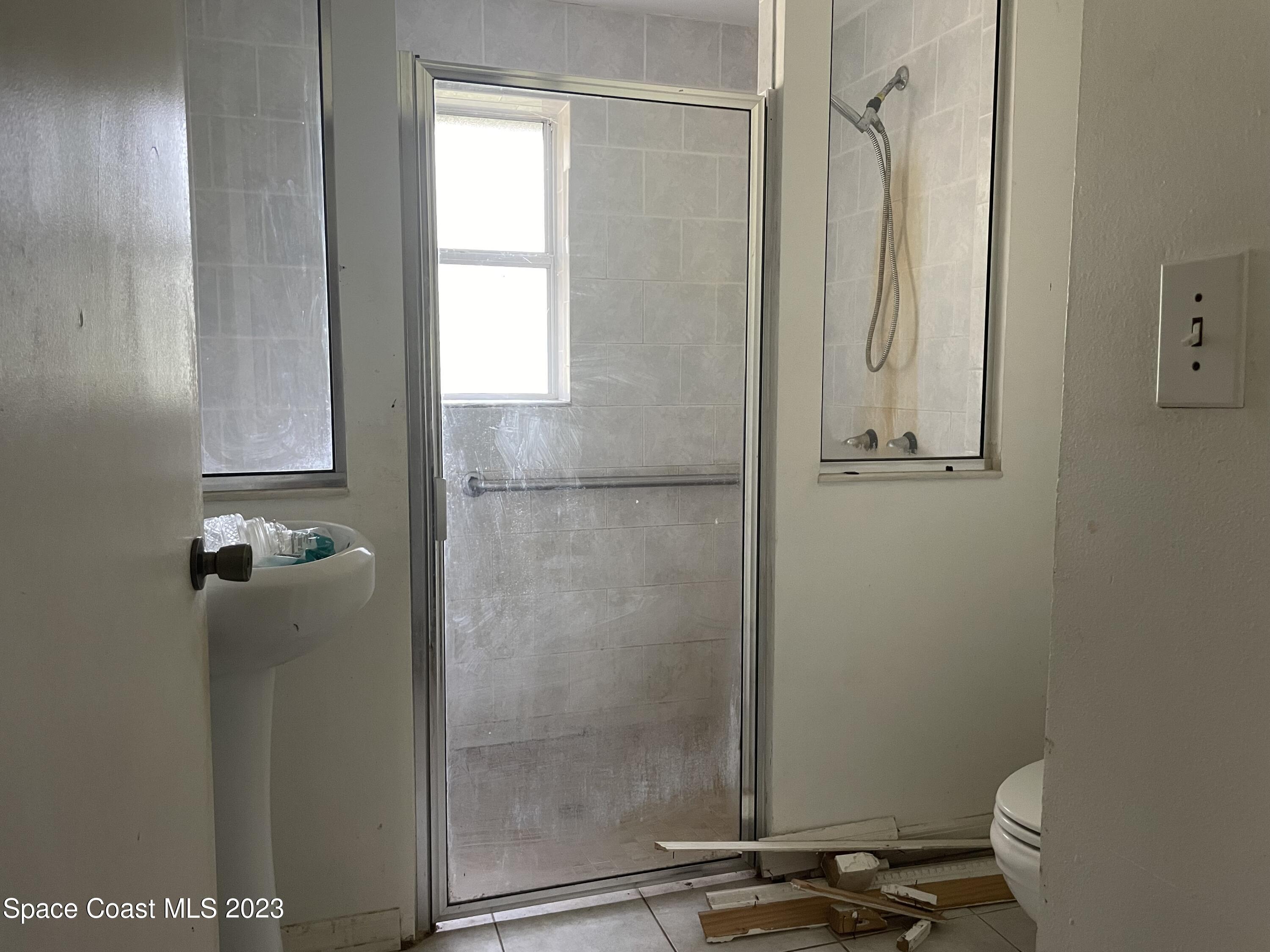 2245 Commodore Boulevard Melbourne, FL 32904 - Photo 13 of 15 a bathroom with a shower
