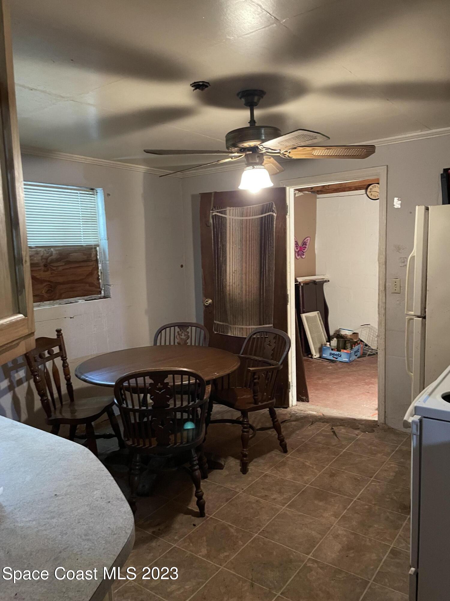 2245 Commodore Boulevard Melbourne, FL 32904 - Photo 15 of 15 a dining room with furniture and a chandelier