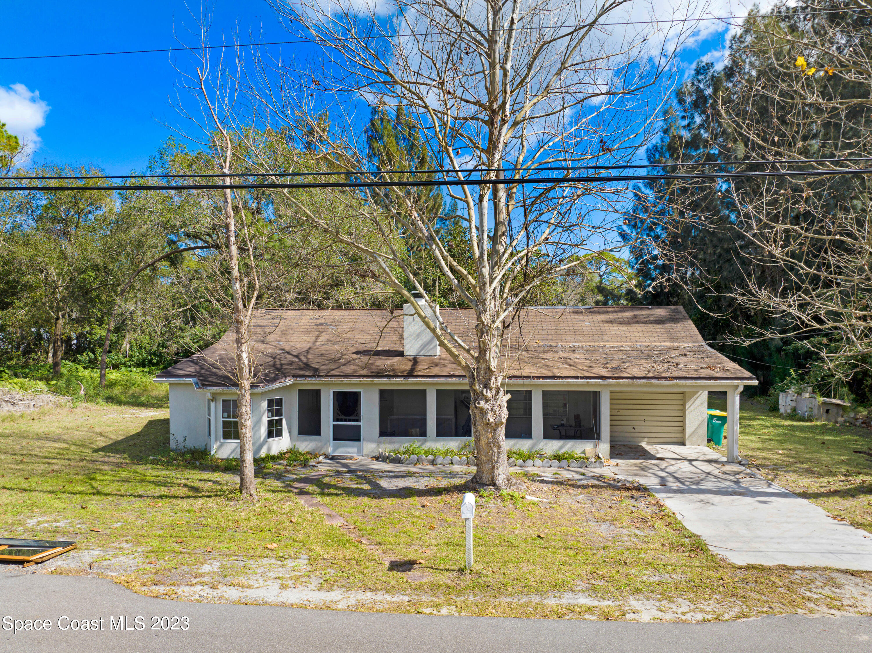 2245 Commodore Boulevard Melbourne, FL 32904 - Photo 2 of 15 a aerial view of a house with swimming pool next to a yard
