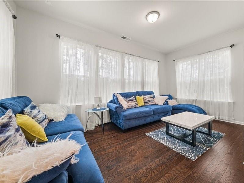 1395 Crestwind Road Northwest Kennesaw, GA 30152 - Photo 12 of 35 a living room with furniture and wooden floor