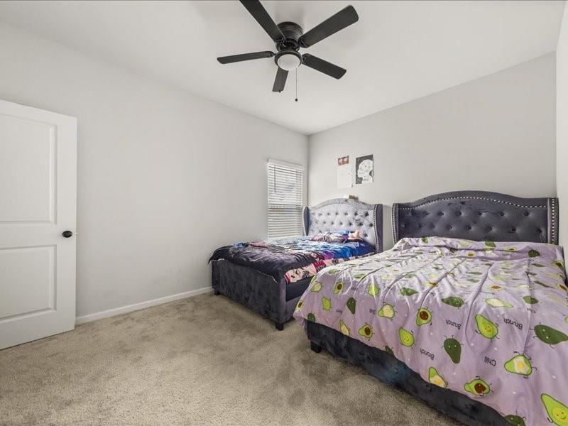 1395 Crestwind Road Northwest Kennesaw, GA 30152 - Photo 13 of 35 a bedroom with two beds and a chandelier