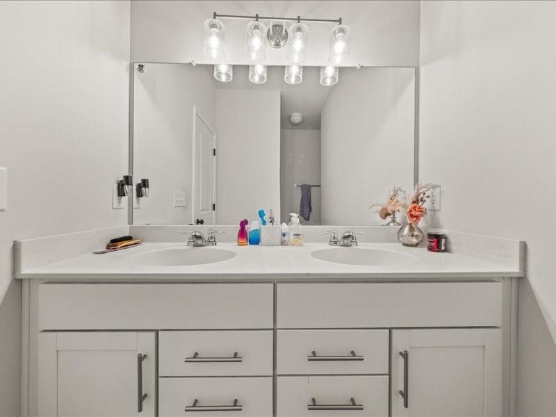 1395 Crestwind Road Northwest Kennesaw, GA 30152 - Photo 14 of 35 a bathroom with a sink and a mirror