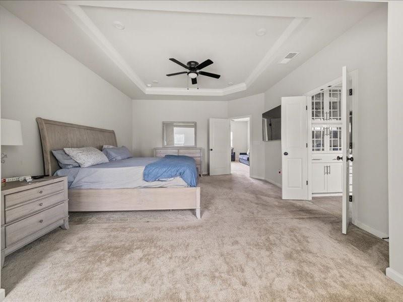 1395 Crestwind Road Northwest Kennesaw, GA 30152 - Photo 17 of 35 a spacious bedroom with a large bed and ceiling fan