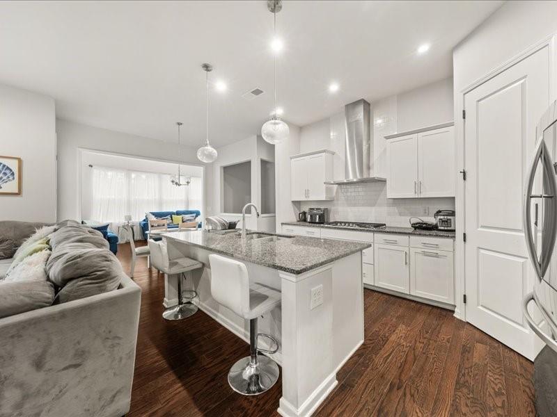 1395 Crestwind Road Northwest Kennesaw, GA 30152 - Photo 2 of 35 a kitchen with stainless steel appliances granite countertop a stove a sink a refrigerator and white cabinets with wooden floor