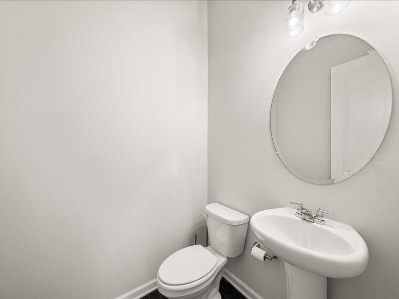 1395 Crestwind Road Northwest Kennesaw, GA 30152 - Photo 24 of 35 a bathroom with a sink a toilet and mirror