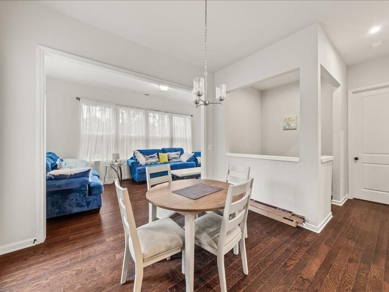 1395 Crestwind Road Northwest Kennesaw, GA 30152 - Photo 6 of 35 a view of a dining room with furniture and wooden floor