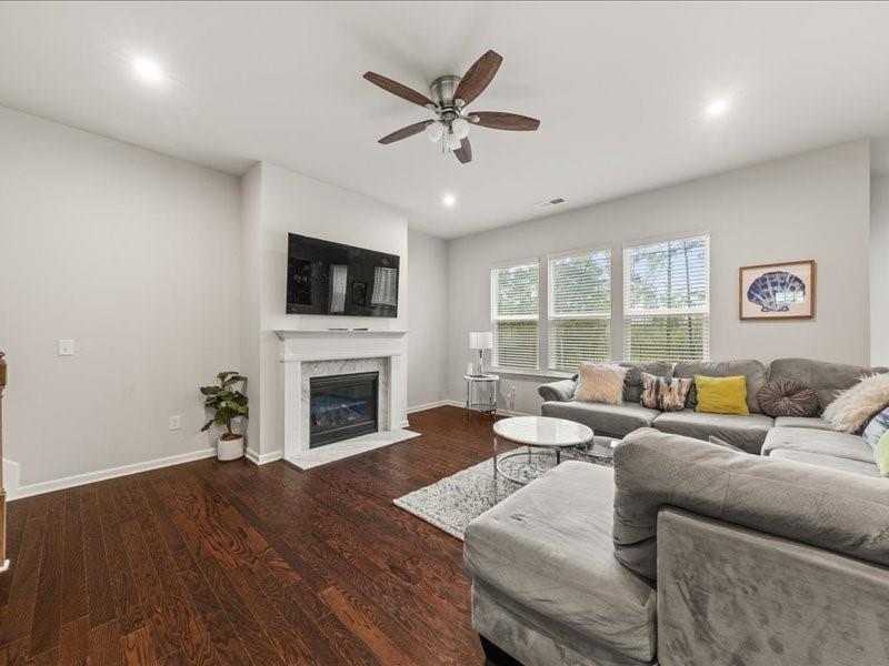 1395 Crestwind Road Northwest Kennesaw, GA 30152 - Photo 9 of 35 a living room with furniture a fireplace and a flat screen tv