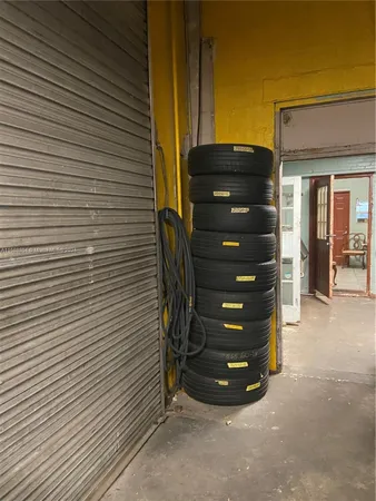 a view of a wooden door and brick wall