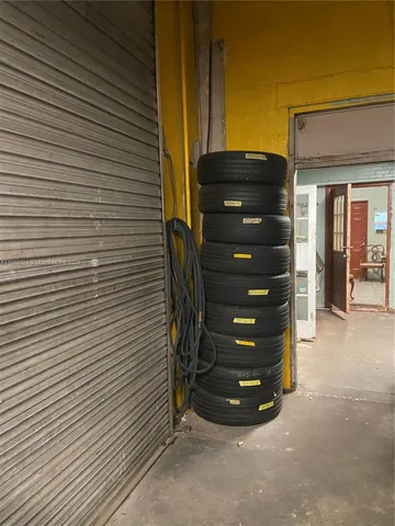 a view of a wooden door and brick wall