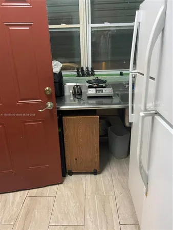 a room with washing machine and cabinets