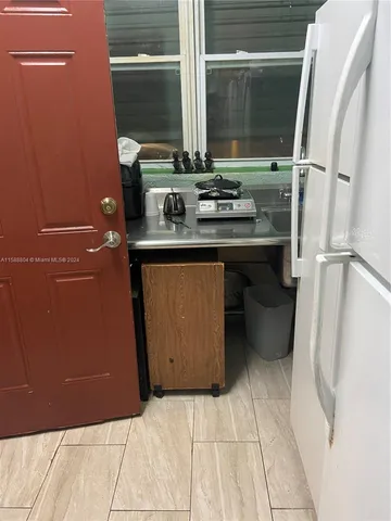 a room with washing machine and cabinets