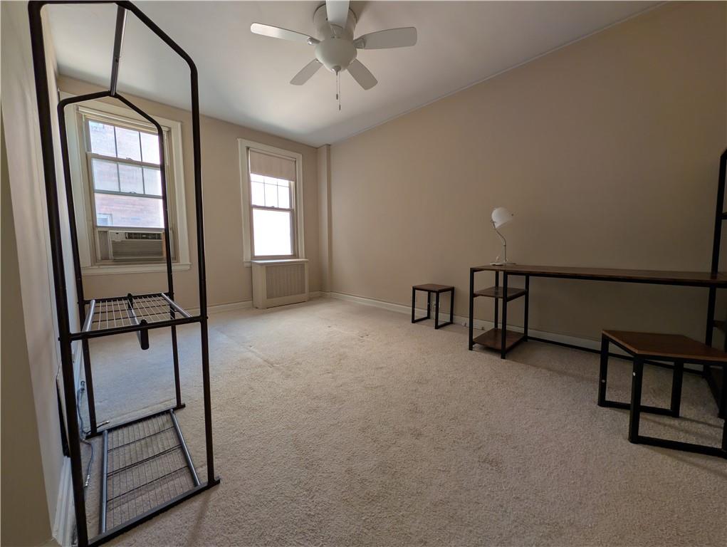 144 North Dithridge Street, Unit 403 Pittsburgh, PA 15213 - Photo 19 of 31 an empty room with windows and stairs