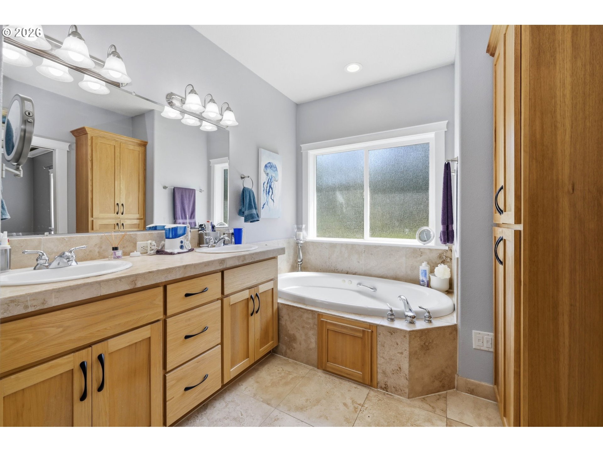 29778 Gimpl Hill Road Eugene, OR 97405 - Photo 21 of 43 a bathroom with a tub a double vanity sink a mirror a window and a bathtub