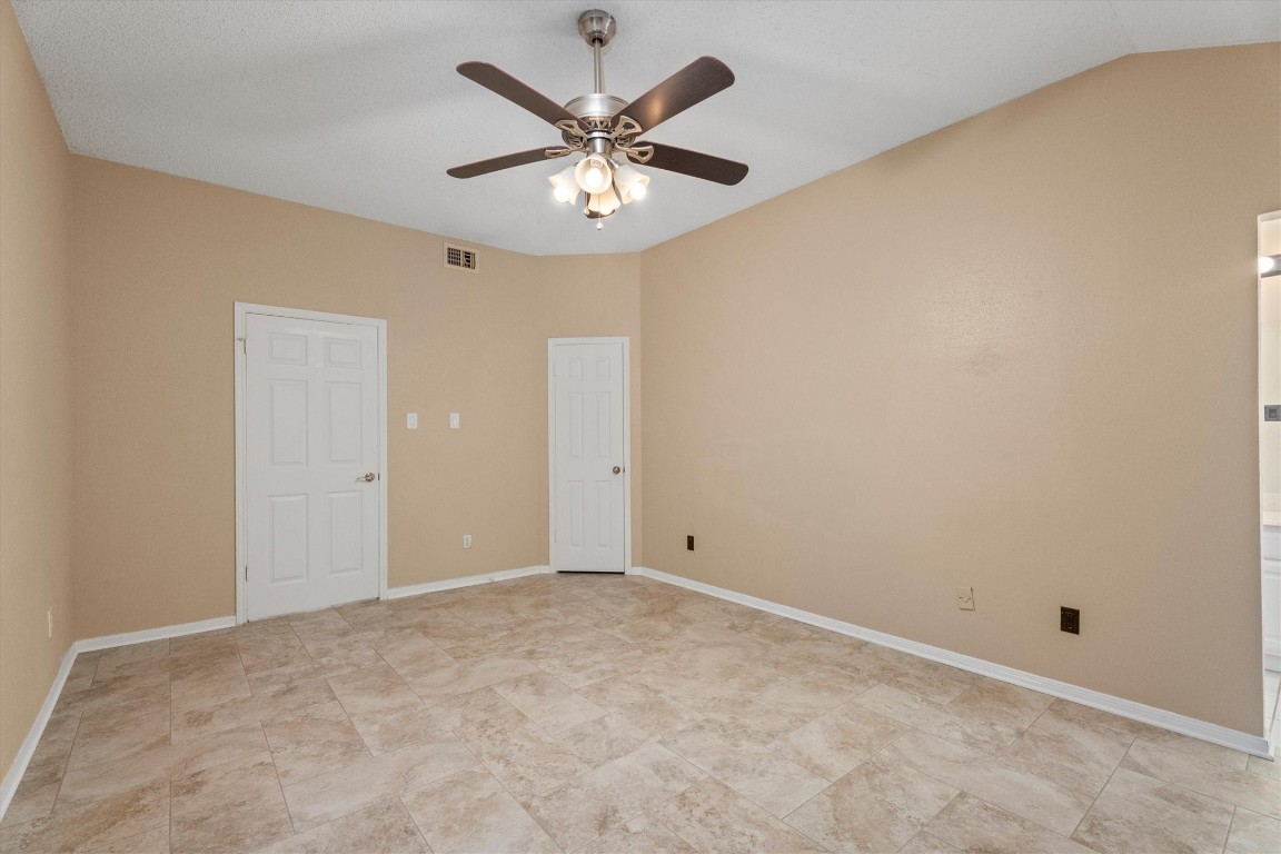 6907 Five Forks Drive Spring, TX 77379 - Photo 34 of 45 Primary bedroom with ceiling fan and neutral palette.