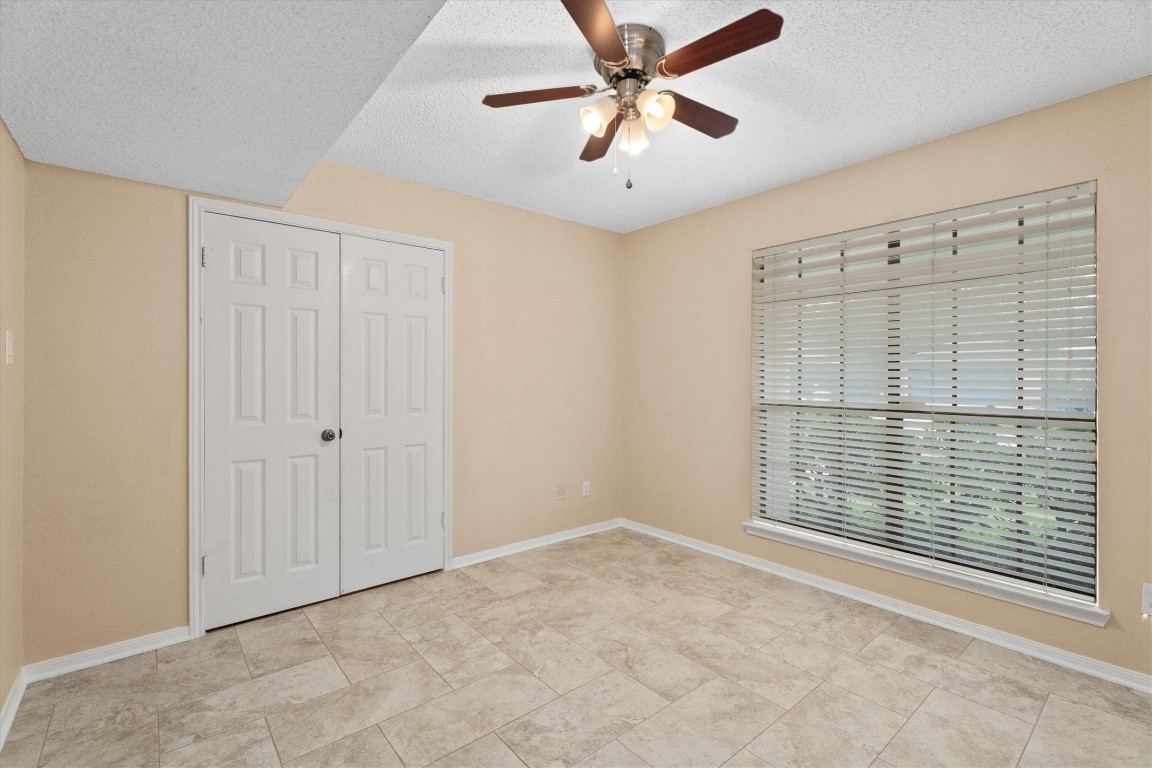 6907 Five Forks Drive Spring, TX 77379 - Photo 38 of 45 Bedroom with ceiling fan, double closet doors, and window views.