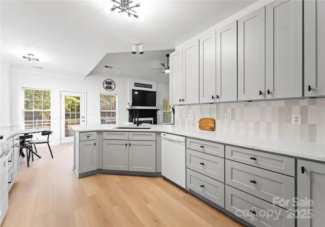a kitchen with cabinets appliances and a window