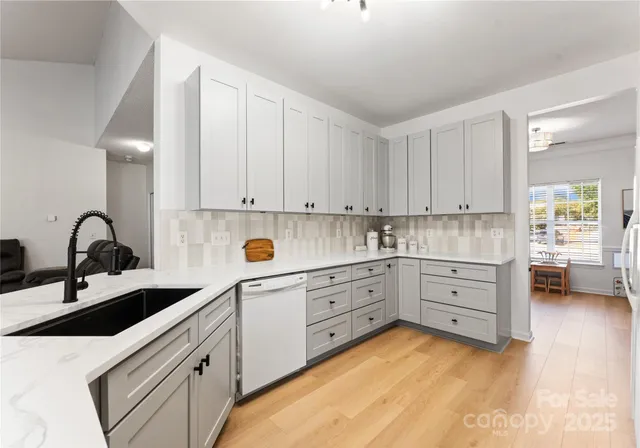a kitchen with sink and cabinets