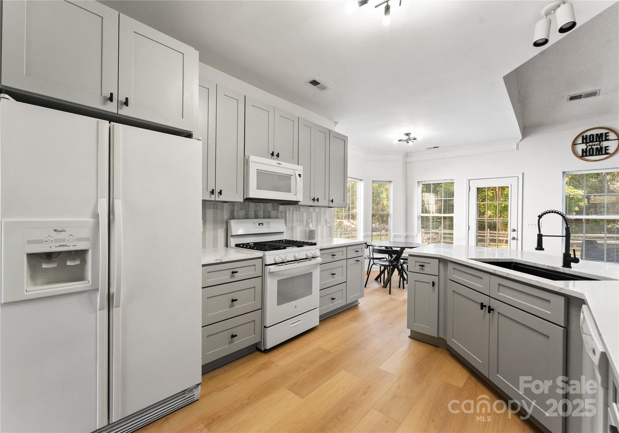 11403 Ridge Oak Drive Charlotte, NC 28273 - Photo 13 of 45 a kitchen with stainless steel appliances white cabinets a sink a stove a refrigerator and white cabinets