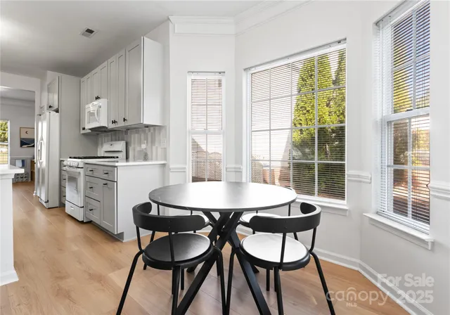 a view of a dining room with furniture and a window